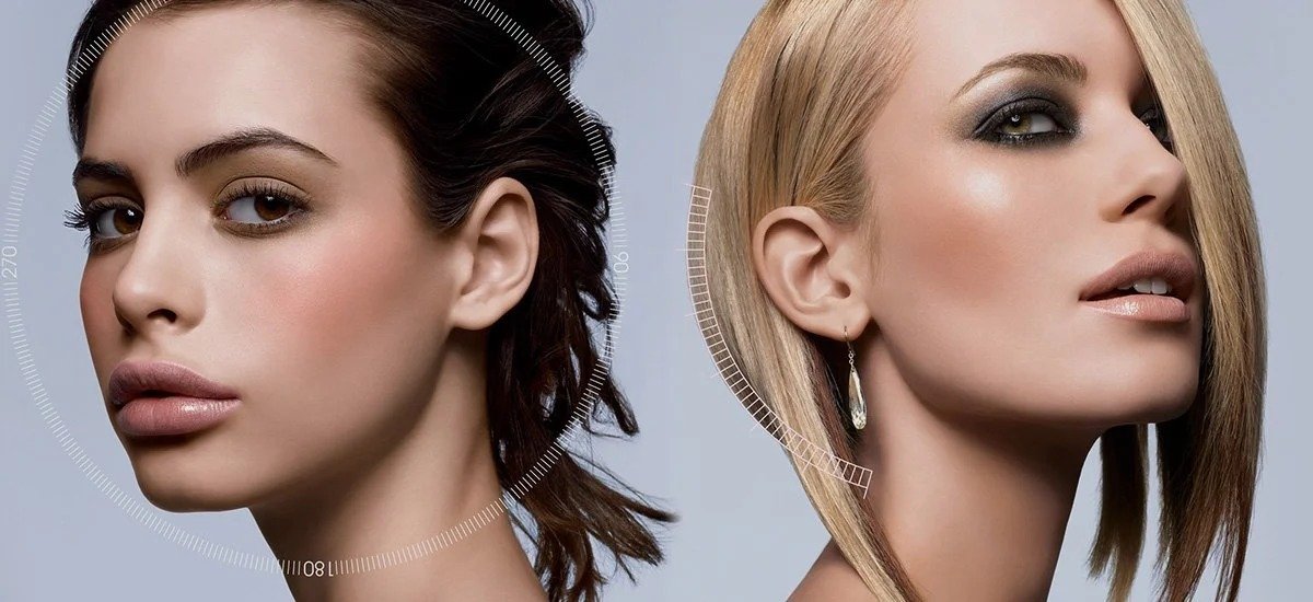 Two women with styled hair and makeup, one with dark brown hair and the other with blonde hair, posing against a light background.